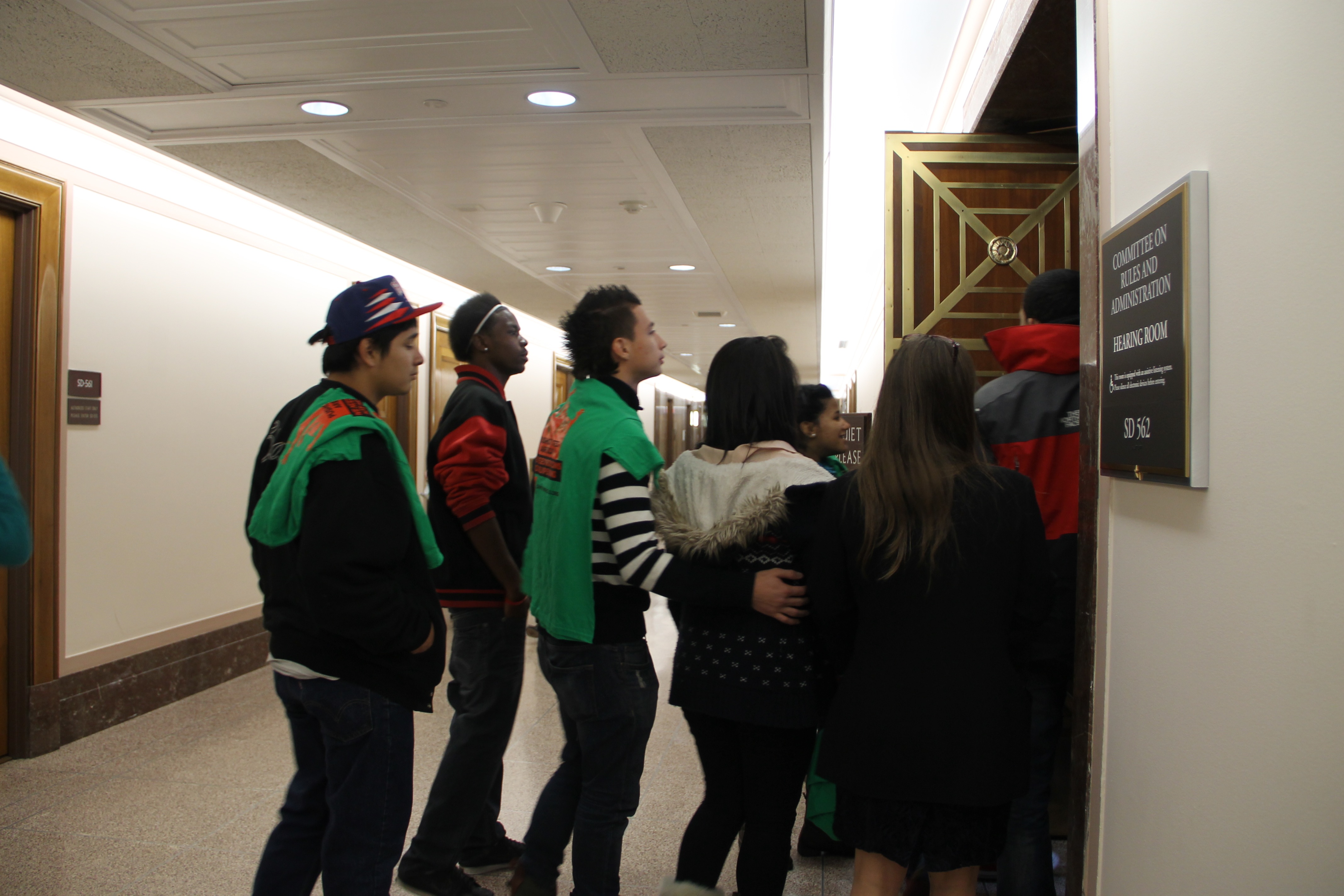 Young people relocate to a senate building overflow room.